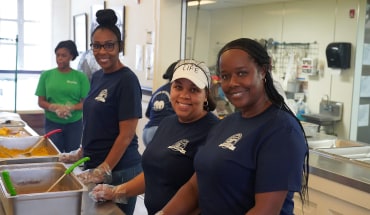 Nissan employees serving warm meals at Jackson Stewpot