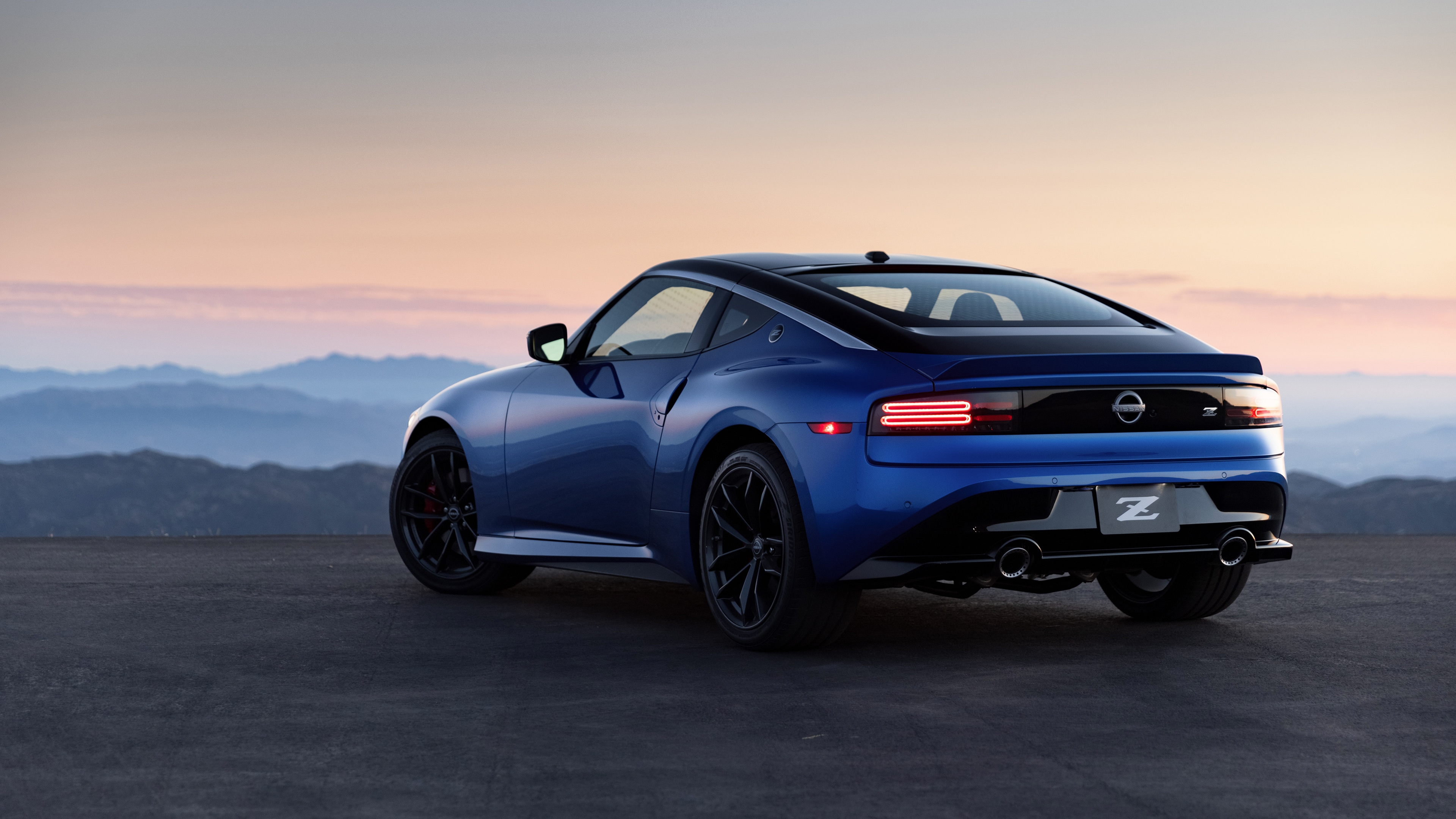 rear-view-of-blue-metallic-2023-nissan-z-at-dusk-with-brake-lights-on-3840x2160.jpg