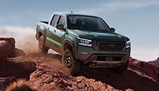 2022 Nissan Frontier off-road going down a steep incline.