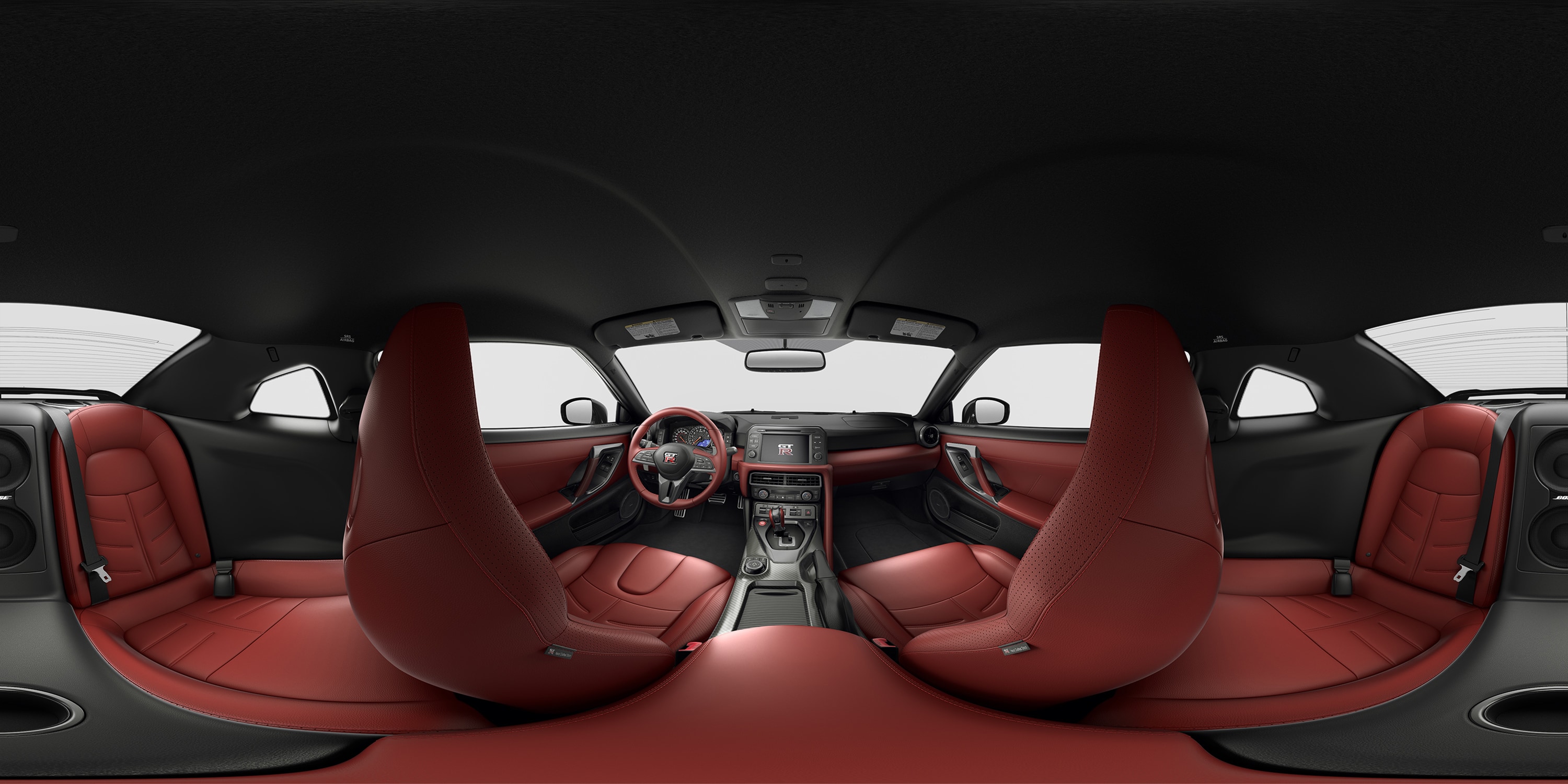 Vista de los asientos delanteros, el volante y el tablero de instrumentos de piel semianilina en tono Red Amber del Nissan GT-R 2023.